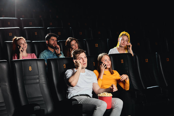 audience with bad manners attending cinema - Fotó, kép