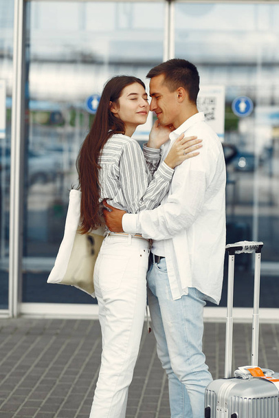 Beautiful couple standing near the airport - Valokuva, kuva