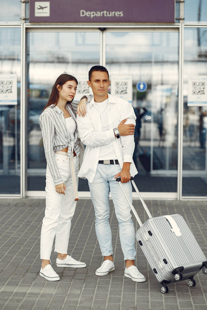 Beautiful couple standing near the airport - Valokuva, kuva