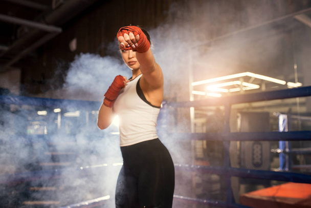 Professional female fighter in ring - 写真・画像