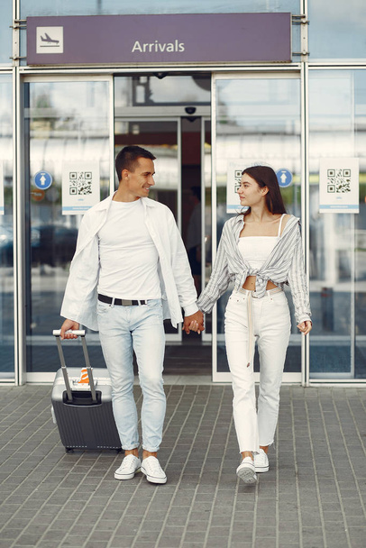 Beautiful couple standing near the airport - Φωτογραφία, εικόνα