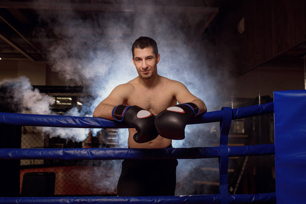 portrait of muscular strong boxer man in smoke - Φωτογραφία, εικόνα