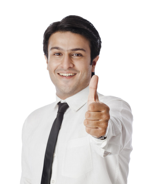 Businessman gesturing thumbs up sign - Foto, immagini