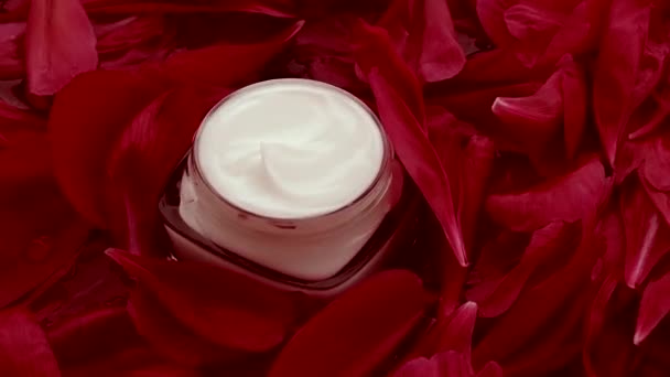 Sensitive skincare moisturizer face cream on flower petals and water background, natural science for skin - Footage, Video