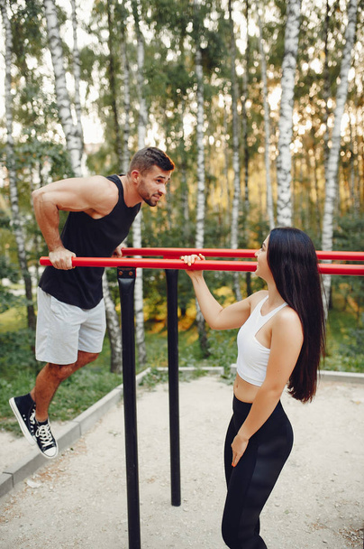 Beautiful couple training in a summer park - Photo, Image