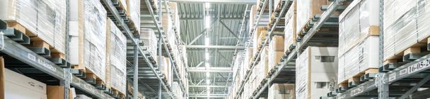 Rows of shelves with boxes in modern warehouse - Photo, Image