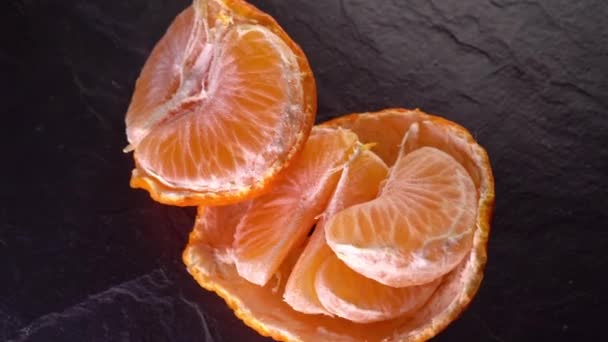 rotating tangerines close up on a dark background - Footage, Video