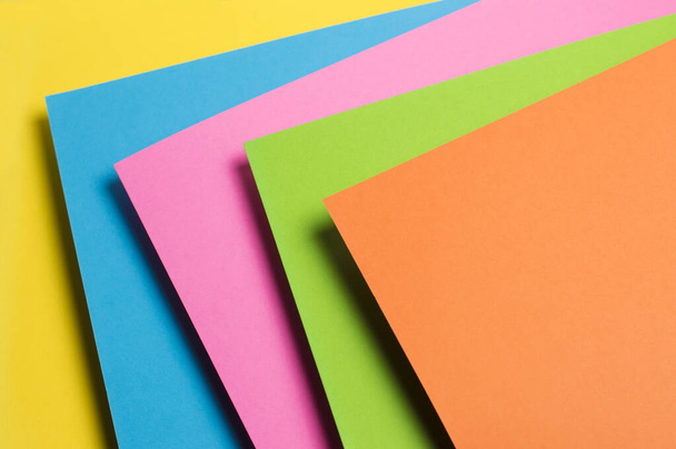 multicolored paper on a yellow background - Photo, Image