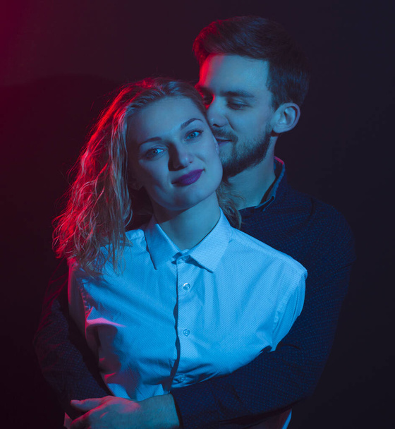young sexy couple portrait photo in multicolored light - Photo, Image