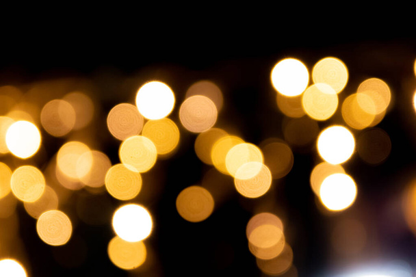 Shiny golden bokeh background for festive celebrations like christmas, silvester and a happy new year party as well as elegant invitation cards to celebrate with glitter rain and noble guests together - Φωτογραφία, εικόνα