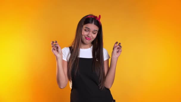 Pretty girl showing with hands and two fingers like quotes gesture, bend fingers isolated over yellow background. Very funny, irony and sarcasm concept. - Materiaali, video