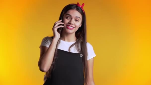 Woman with long hair talking with somebody by mobile phone. Girl smiling, having pleasant conversation. Technology, mobile connection concept. - Materiał filmowy, wideo