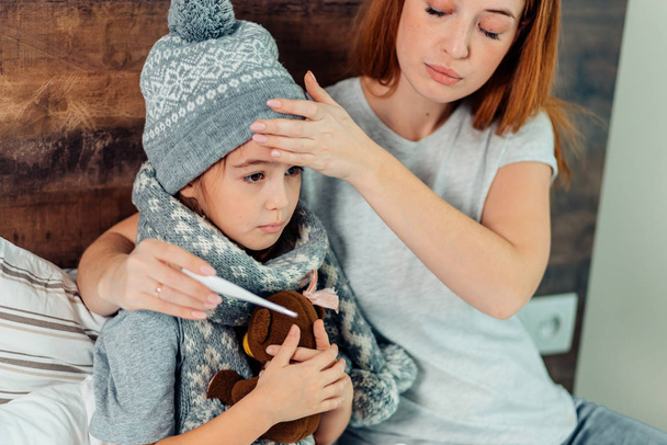 careful mother checking temperature of kid girl - Photo, image