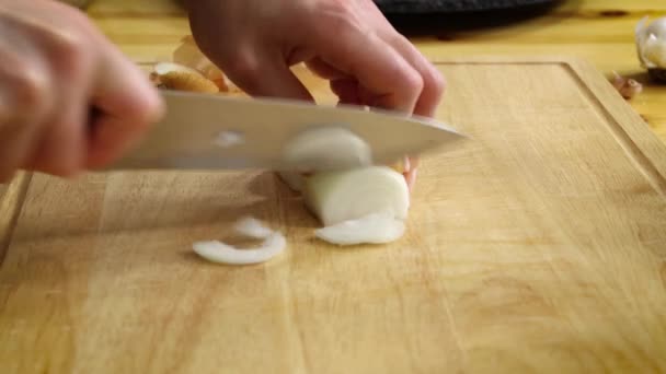 Chopping white onion on cutting board - Footage, Video