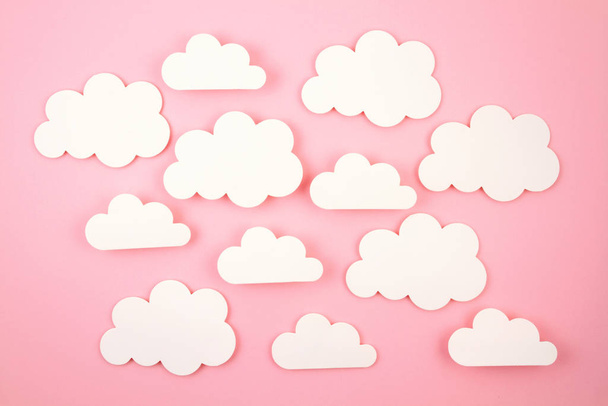 Fehér papír kivágta felhők felett rózsaszín háttér. - Fotó, kép