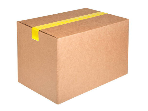 Cardboard box with yellow sticky tape isolated on white background - Фото, зображення
