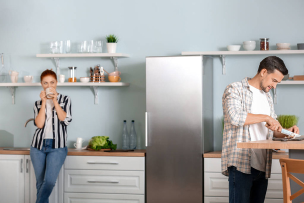 Beautiful couple in kitchen at home - Zdjęcie, obraz