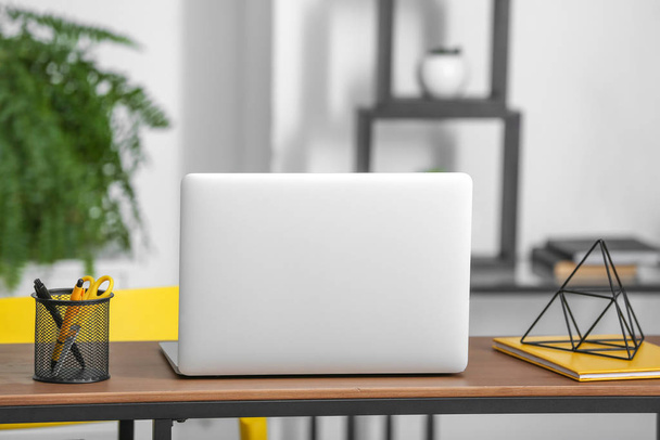 Modern laptop on comfortable workplace in room - Фото, зображення