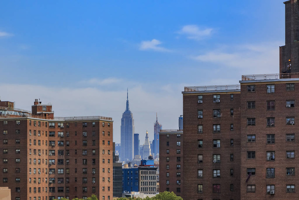 Skyscrapers of Midtown Manhattan, country's commercial and media center behind brick facades in Lower Manhattan New York - Φωτογραφία, εικόνα