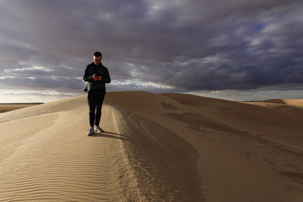 Siwa-Oase, Ägypten Ein Mann geht auf den Sanddünen außerhalb der Oase. - Foto, Bild