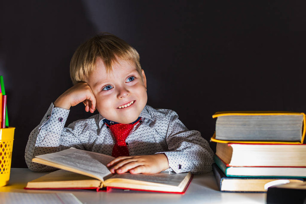 cheerful preschooler boy on the background of the blackboard. - Photo, Image