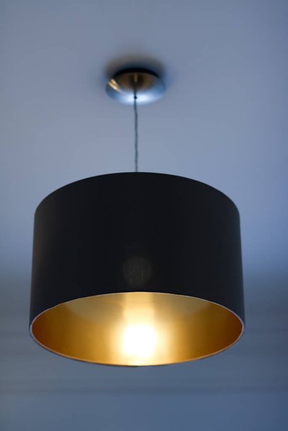 Golden lamp in a room, elegant modern home decor lighting - Foto, immagini