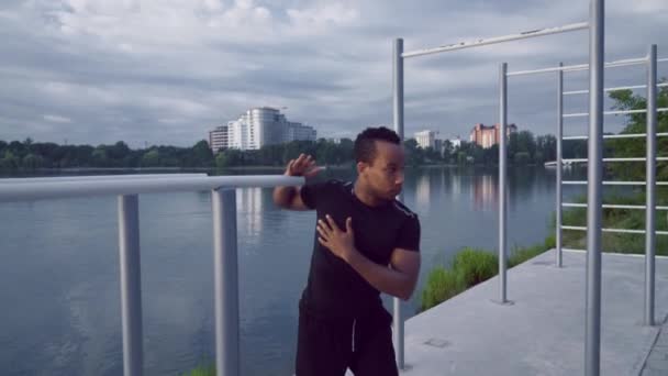 Afro american muscular man doing push ups on sports ground - Felvétel, videó