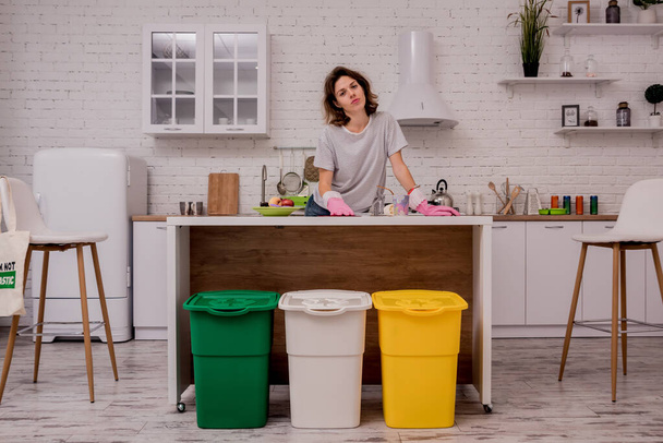 Young girl sorting garbage at the kitchen. Concept of recycling. Zero waste - Fotoğraf, Görsel