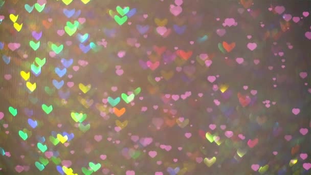 little hearts falling on the floor and blur rainbow shape heart background - Footage, Video