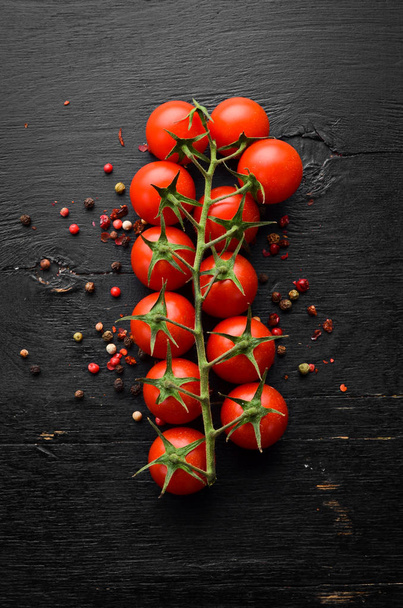 Fresh cherry tomatoes on a twig. In the old background. Top view. Free space for your text. - Foto, afbeelding