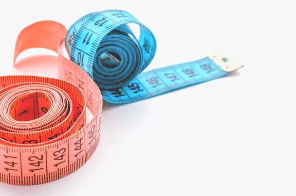 centimeter ribbon pink and blue on a white background. The concept of weight loss and a healthy lifestyle. - Foto, Bild