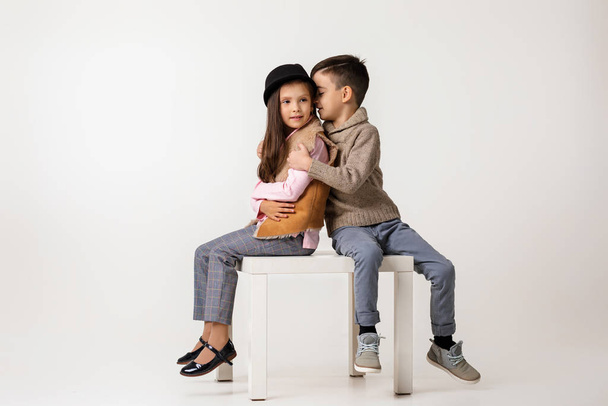 Cute stylish little couple child girl and boy sittting together . - Photo, Image