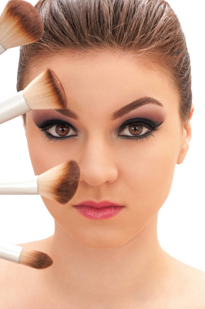 Young beautiful model with professional make up and big brush on - Photo, Image