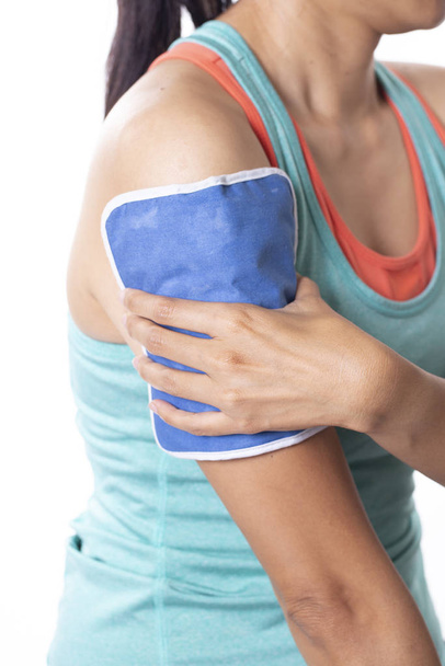 woman putting an ice pack on her arm pain, isolated white backgr - Foto, Bild