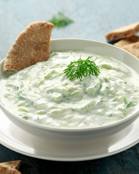 Tzatziki dip sauce with greek yogurt, garlic, dill and cucumber in white bowl - Foto, imagen
