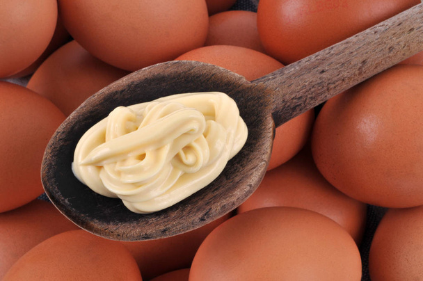 Wooden spoon of homemade mayonnaise on eggs - Photo, Image