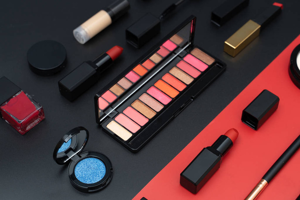 set decorative cosmetics on black and red - Foto, imagen