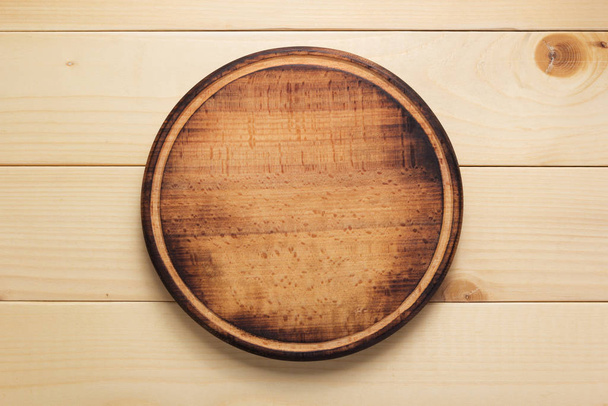 pizza cutting board at rustic wooden plank background - 写真・画像