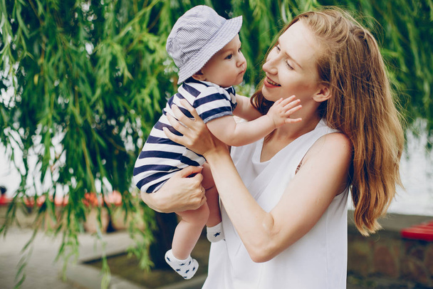 Mom and son relax in the park and walking around the river. - 写真・画像