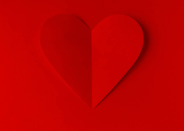 Red paper heart on a red background. Valentine's Day. Valentine's Day. Love and heart - Fotoğraf, Görsel