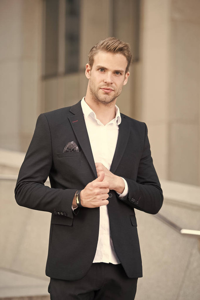 Businessman lifestyle. Fashionable young successful businessman. Businessman handsome attractive office worker confident face. Man well groomed elegant formal suit urban background defocused - 写真・画像