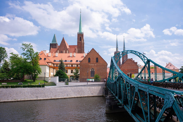 Wroclaw Poland view at Tumski island and Cathedral of St John the Baptist with bridge through river Odra. Picturesque landscape summer day blue sky white cloud. - Zdjęcie, obraz