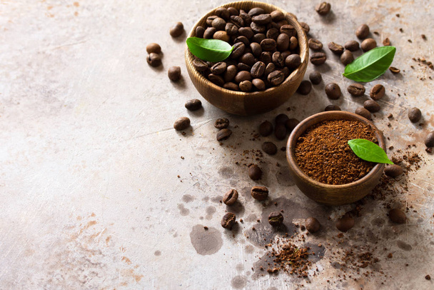 Coffee background. Coffee beans and ground powder on a stone con - Photo, Image