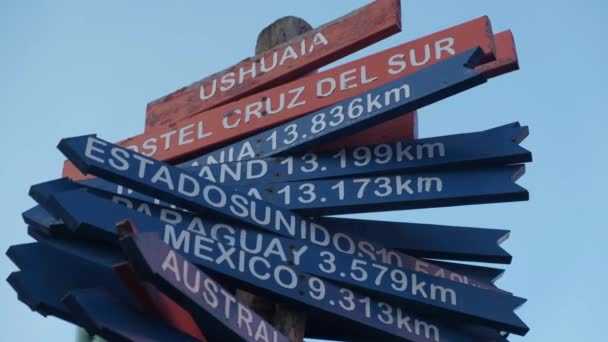 View of directions and distance to countries on wooden post in Ushuaia - Footage, Video