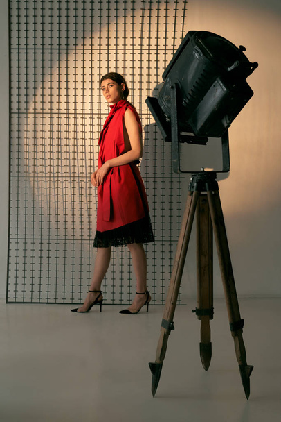 Lady in red posing in studio. - Foto, afbeelding
