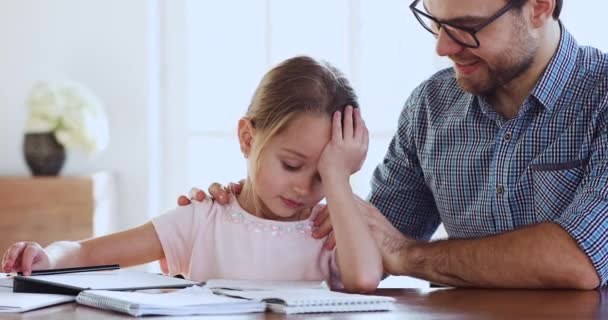 Caring dad support encourage sad tired child daughter studying together - Materiał filmowy, wideo
