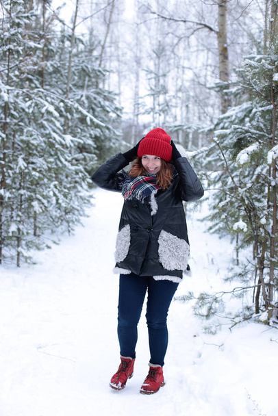 young woman with ginger hair on a winter walk in the forest cold weather and good romantic mood - Photo, Image