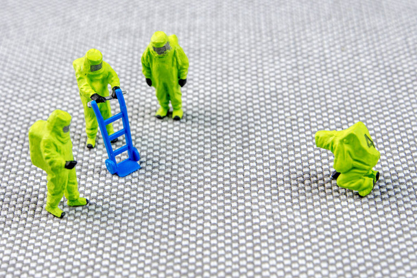 Nahaufnahme von Miniaturfiguren, die wie Mitglieder einer Feuerwehrstaffel gekleidet sind - Foto, Bild