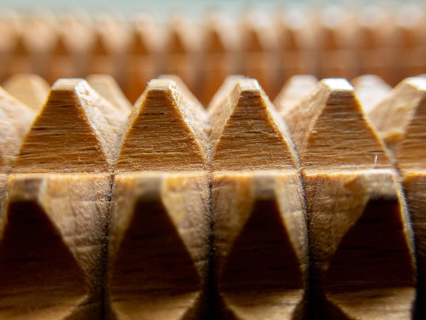 Macro of a wooden massage tool - wooden spikes/pyramids background (selective focus effect) - Photo, Image