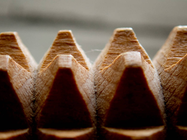 Macro of a wooden massage tool - wooden spikes/pyramids background (selective focus effect) - Photo, Image